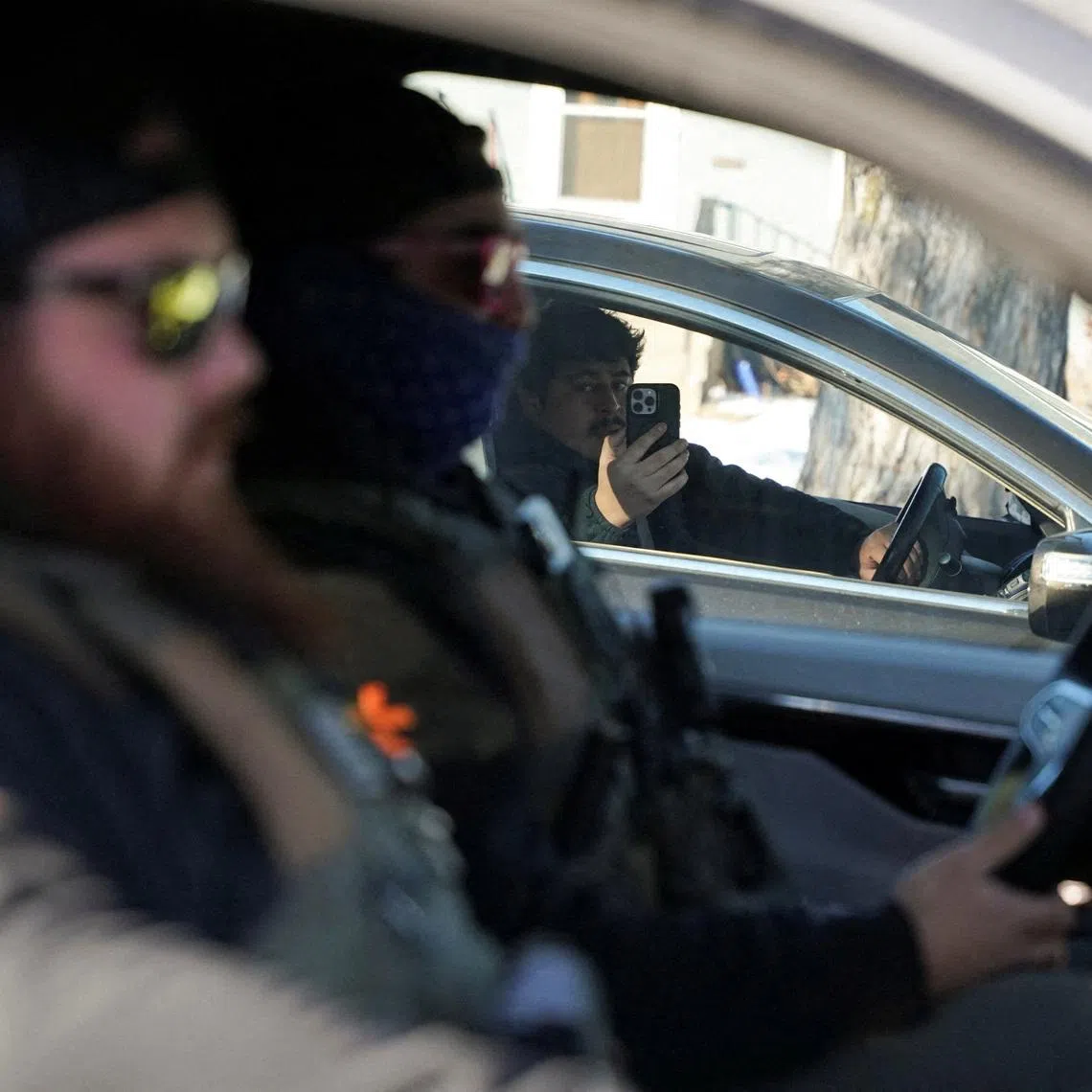 A community member films federal agents conducting an immigration enforcement action in Saint Paul, Minnesota, U.S. REUTERS/Seth Herald