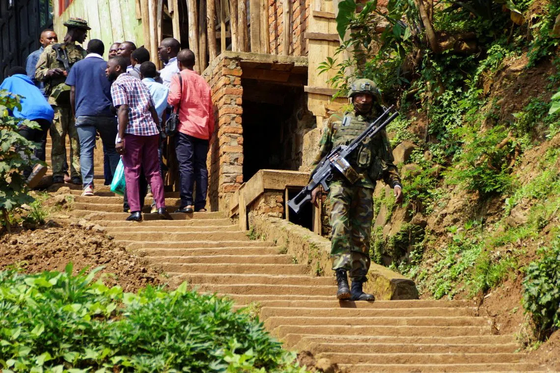 FILE PHOTO: A member of the M23 rebel group checks people before attending a rally addressed by Corneille Nangaa, Congolese rebel leader and coordinator of the AFC-M23 movement, in Bukavu, eastern Democratic Republic of Congo February 27, 2025. REUTERS/Victoire Mukenge/File Photo