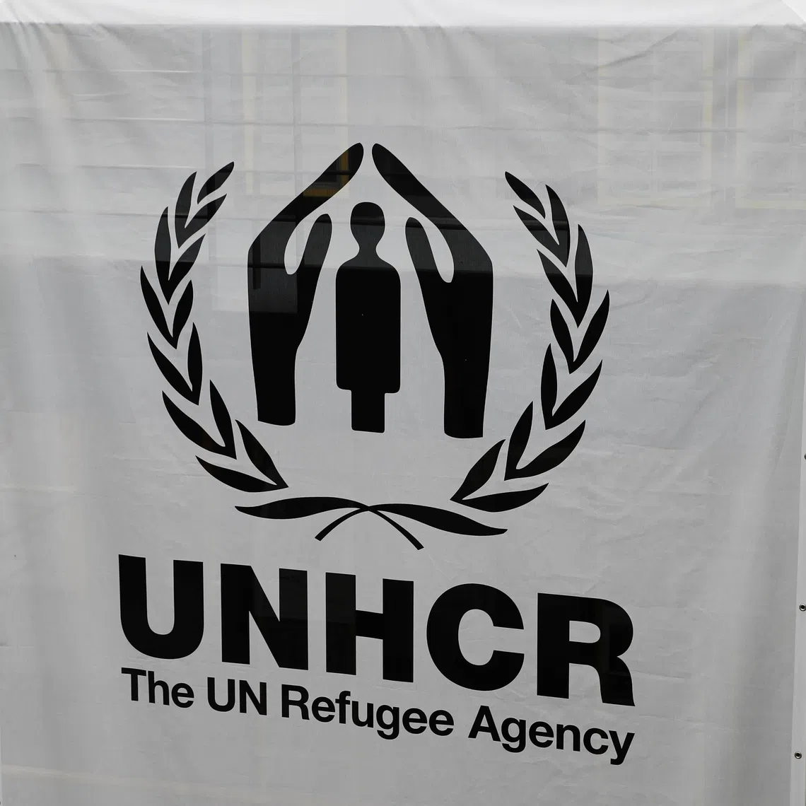 A logo is pictured on a banner at the UNHCR headquarters in Geneva, Switzerland June 13, 2018. REUTERS/Denis Balibouse