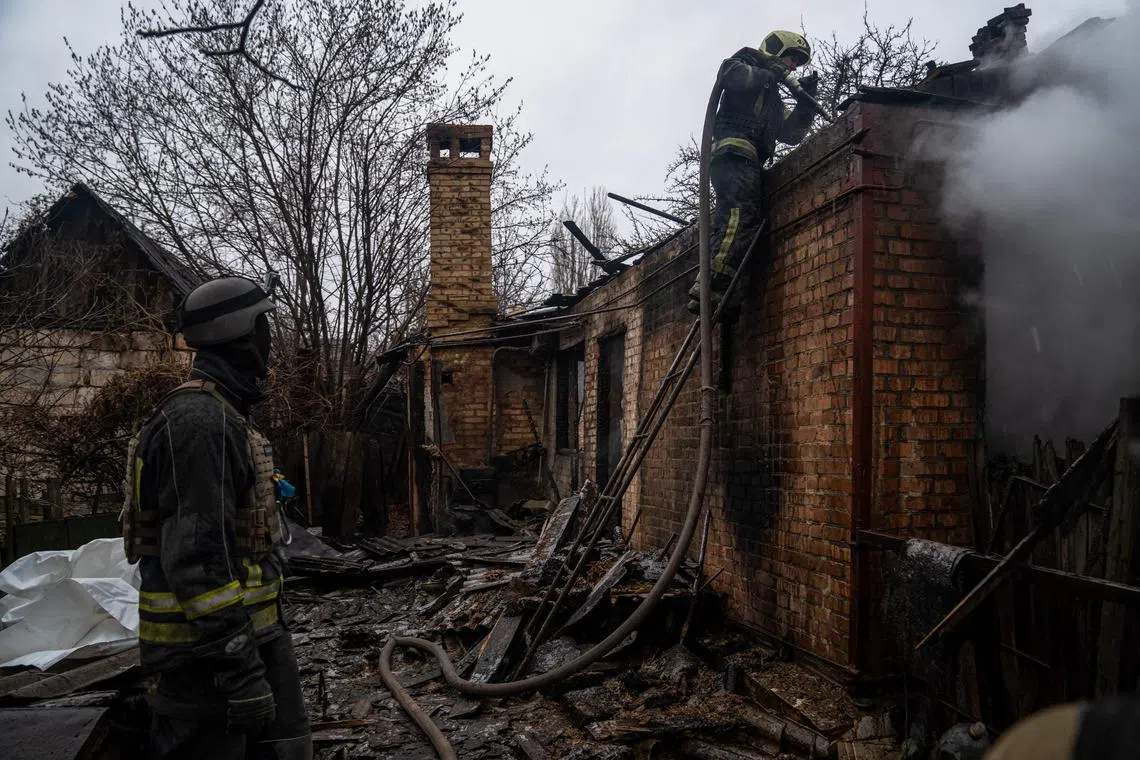 Firefighters extinguish a fire in a residential area of Bakhmut, on Dec 8, 2022.