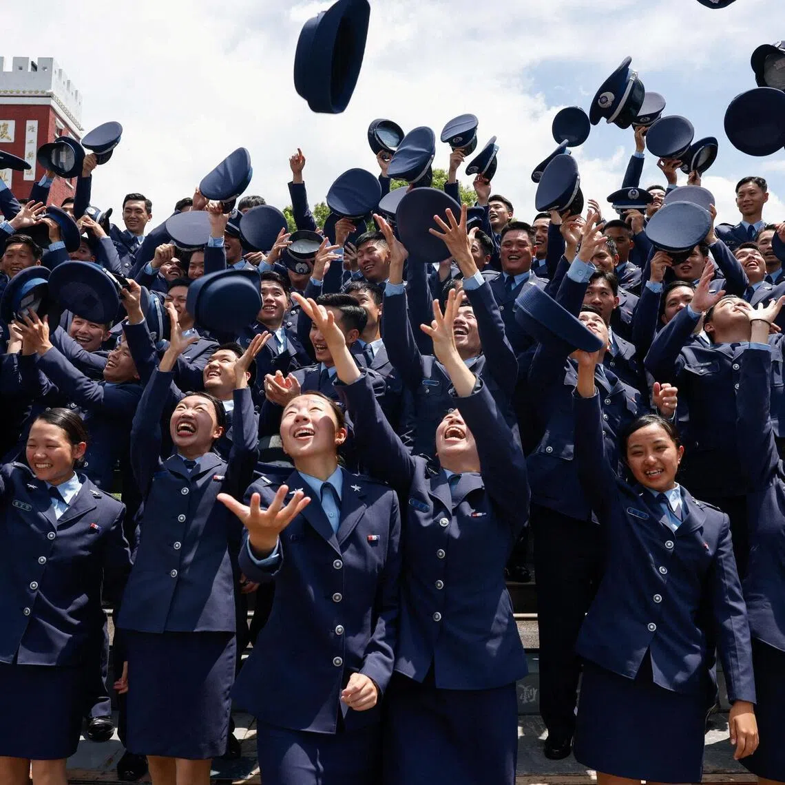 Military cadets toss their caps following a graduation ceremony in Taipei, Taiwan on June 30.