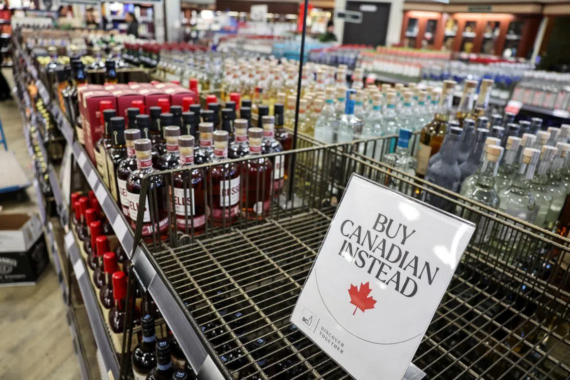 An empty shelf remains with a sign ''Buy Canadian Instead'' after the top five US liquor brands were removed from sale at a B.C. Liquor Store on Feb 2.