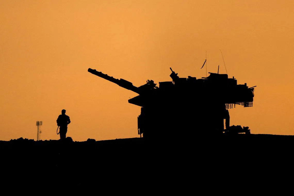 FILE PHOTO: The silhouettes of a military vehicle and a soldier are seen near the Gaza border, amid the ongoing conflict in Gaza between Israel and Hamas, in Israel, December 16, 2024. REUTERS/Amir Cohen/File Photo