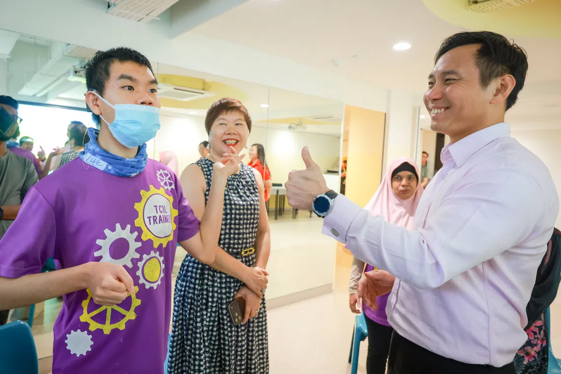 Senior Minister of State for Social and Family Development Goh Pei Ming (right) meeting TOUCH client Sherman, who has an intellectual disability, deafness, cerebral palsy and epilepsy, and mother Wu Ping at Enabling Village on Sep 17.