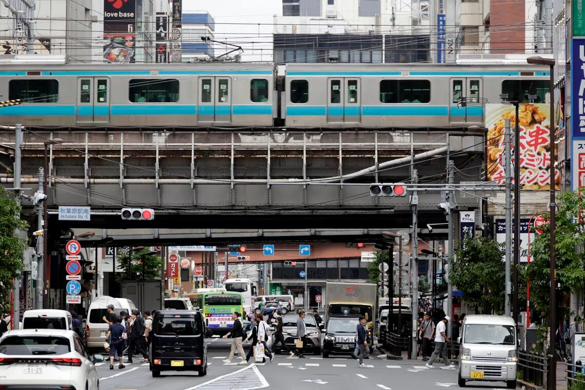 People cross a street in Akihabara in Tokyo, Japan, on June 8. 