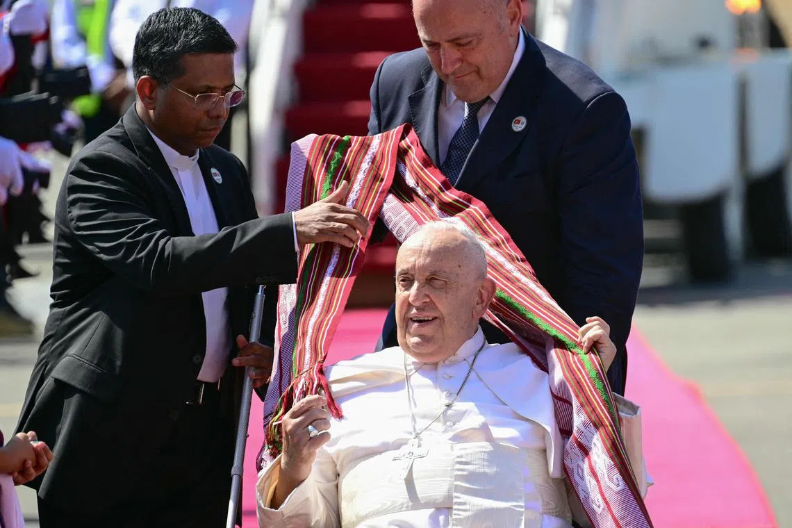 Pope Francis is greeted upon his arrival at Presidente Nicolau Lobato International Airport in Dili on Sept 9, 2024.