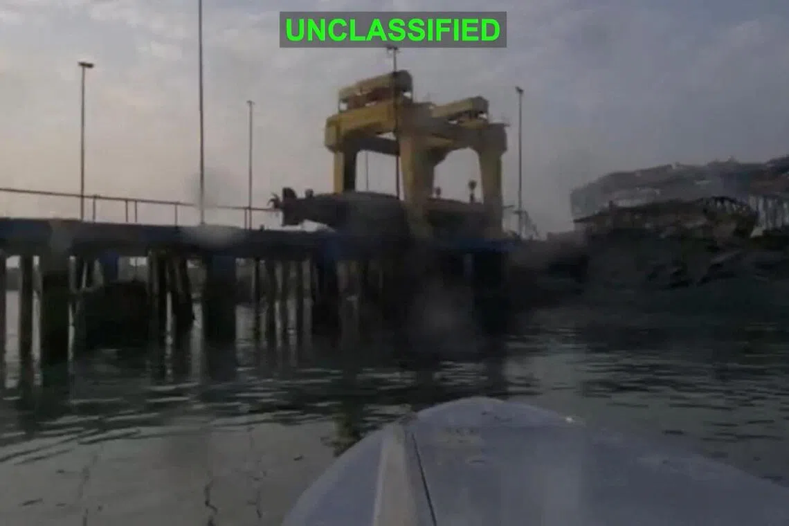 A US one-way attack surface drone approaches its target, a submarine and ship maintenance facility, in Bandar Abbas, Iran, as seen in this screengrab released July 13.