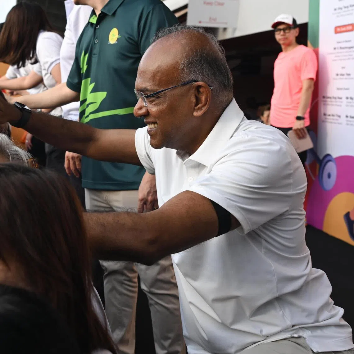 Home Affairs Minister K Shanmugam greeting participants during the brisk walk at the annual Healthy Living Festival @ North West on June 7.