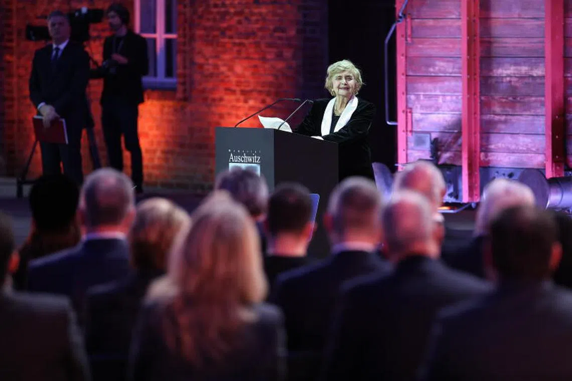 epa11856952 Holocaust survivor Tova Friedman delivers a speech at a ceremony commemorating the 80th anniversary of liberation of the former German Nazi concentration and extermination camp KL Auschwitz-Birkenau in front of the historic gate of the former KL Auschwitz II-Birkenau in Brzezinka, Poland, 27 January 2025. The largest German Nazi extermination camp, KL Auschwitz-Birkenau, was liberated by the Red Army on 27 January, 1945. The world commemorates its liberation every year on January 27 as International Holocaust Remembrance Day. EPA-EFE/LUKASZ GAGULSKI POLAND OUT