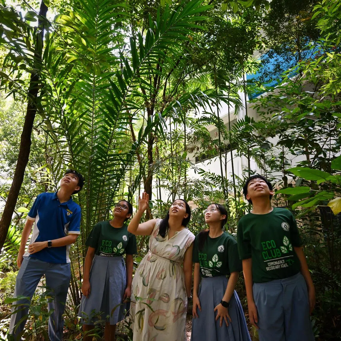 Teacher Lye Zhen Xi (in white) with students from the school's Eco Club in the Rainforest area in Commonwealth Secondary School.