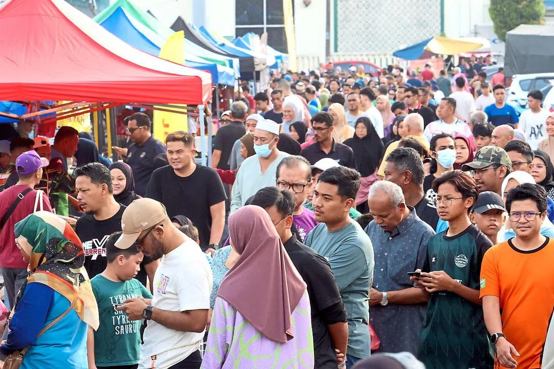 People flocking to a Ramadan bazaar at Bandar Baru Uda in Johor Baru to buy food and drinks to break fast. 