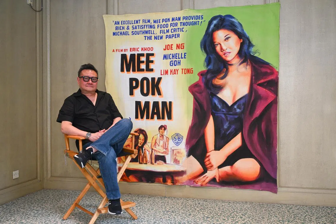 ST20250804_202599800411 Azmi Athni jseric06//

Singaporean filmmaker Eric Khoo poses with his original Mee Pok Man movie canvas used by Shaw cinema when the movie was released in 1995, on Aug 4, 2025.

ST PHOTO: AZMI ATHNI