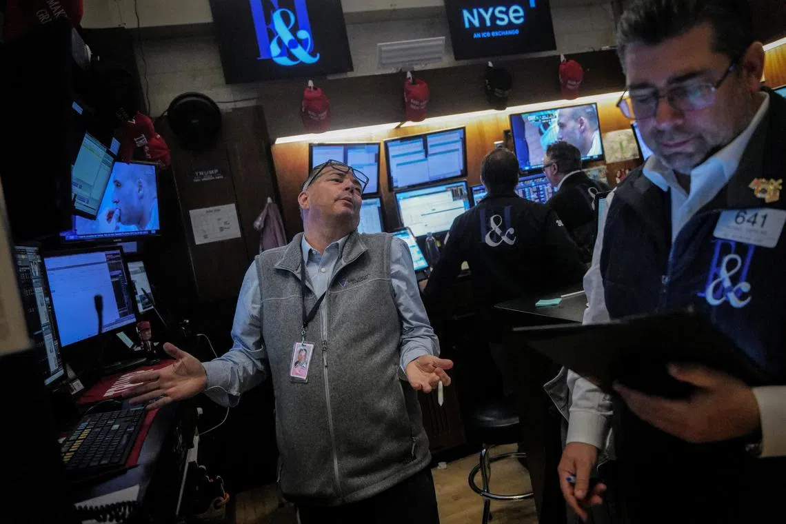 Traders work on the floor at the New York Stock Exchange (NYSE) in New York City, U.S., June 26, 2025. REUTERS/Jeenah Moon