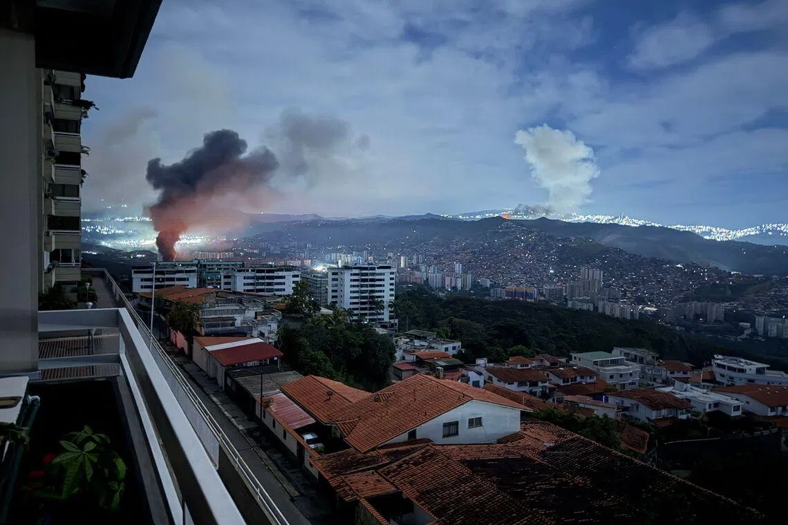 Smoke billowing over Caracas after a series of explosions during a US military operation that led to the capture of Venezuelan President Nicolas Madruo on Jan 3.