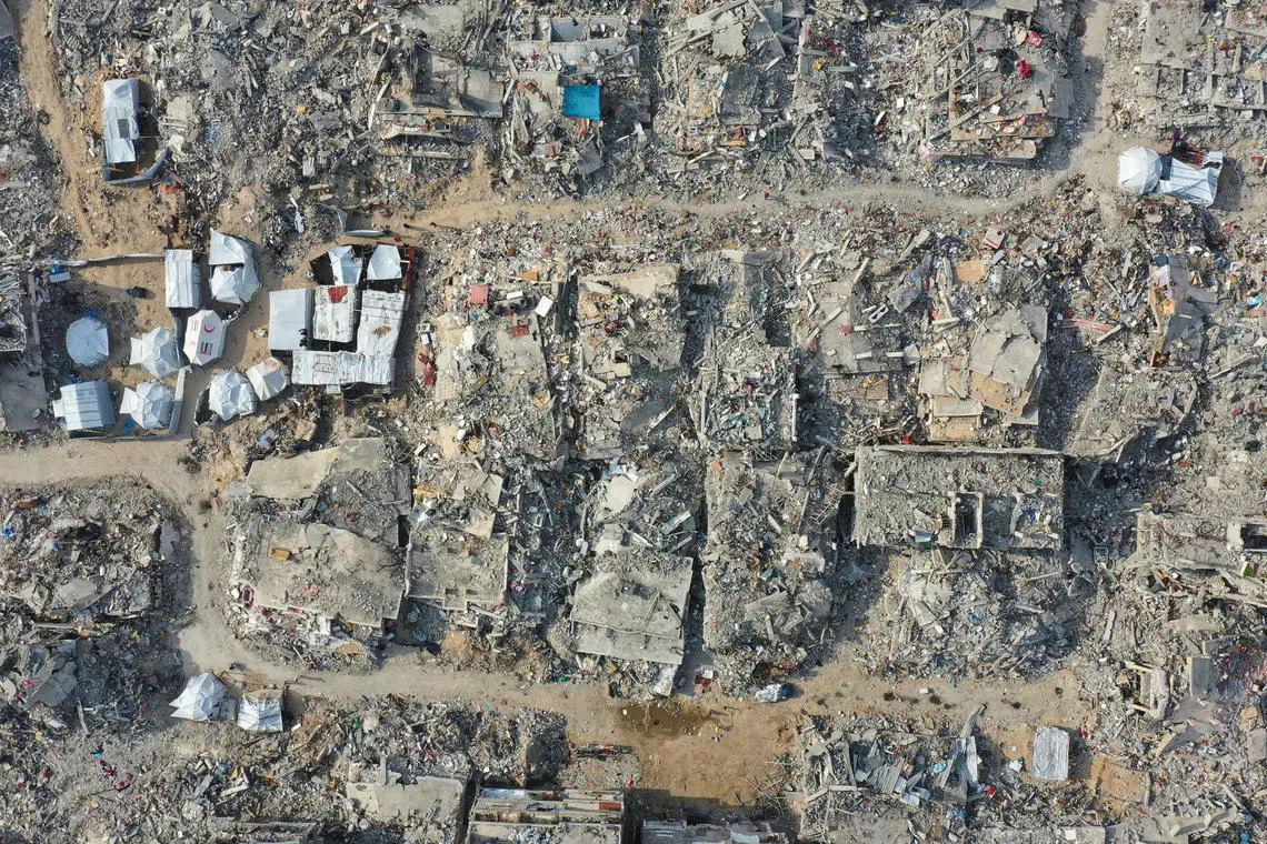 FILE PHOTO: A drone view shows houses destroyed during the Israeli offensive, amid a ceasefire between Israel and Hamas, in Beit Hanoun, northern Gaza Strip, March 5, 2025. REUTERS/Mahmoud Al-Basos/File Photo