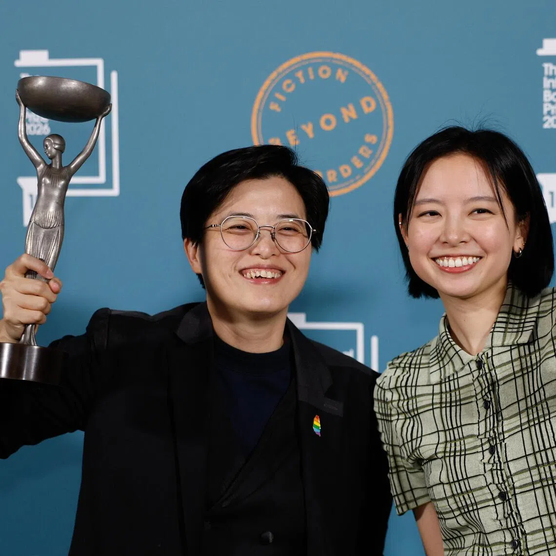 Yang Shuang-zi (left), author of Taiwan Travelogue, and translator Lin King pose with the 2026 International Booker Prize trophies at the Tate Modern in London on May 19.