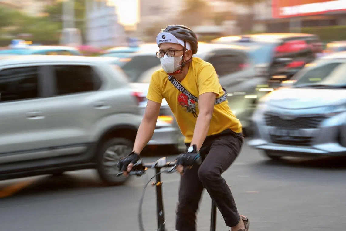 A man wears a face mask due to high levels of pollution, as he commutes in downtown Jakarta, Indonesia.