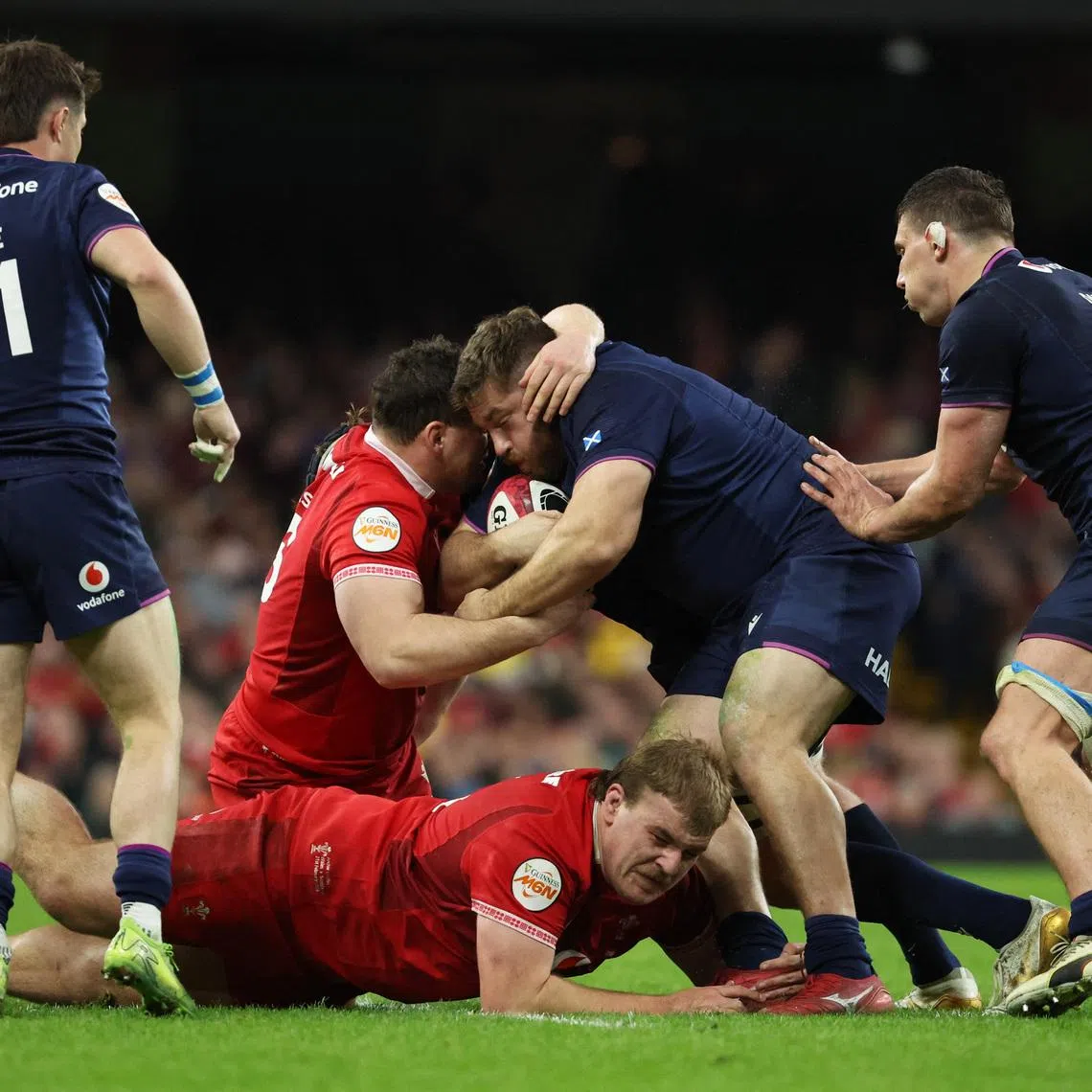 Rugby Union - Six Nations Championship - Wales v Scotland - Principality Stadium, Cardiff, Wales, Britain - February 21, 2026 Scotland's Elliot Millar Mills in action with Wales' Archie Griffin and Ryan Elias. REUTERS/Cat Goryn