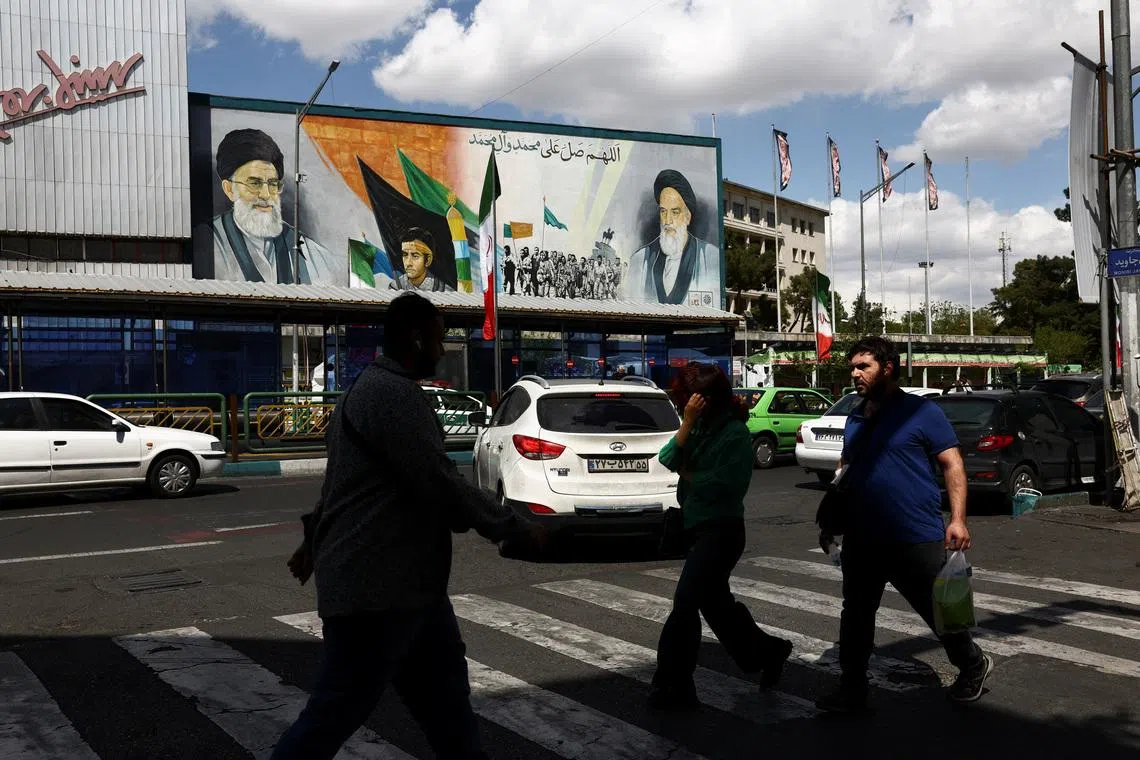 People walk on a street after U.S. President Donald Trump said that he had agreed to a two-week ceasefire with Iran, in Tehran, Iran, April 8, 2026. Majid Asgaripour/WANA (West Asia News Agency) via REUTERS