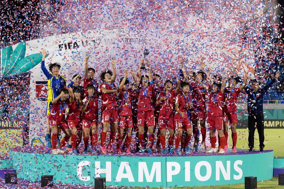 North Korea's players celebrate with the trophy after winning the FIFA U-17 women’s football World Cup.