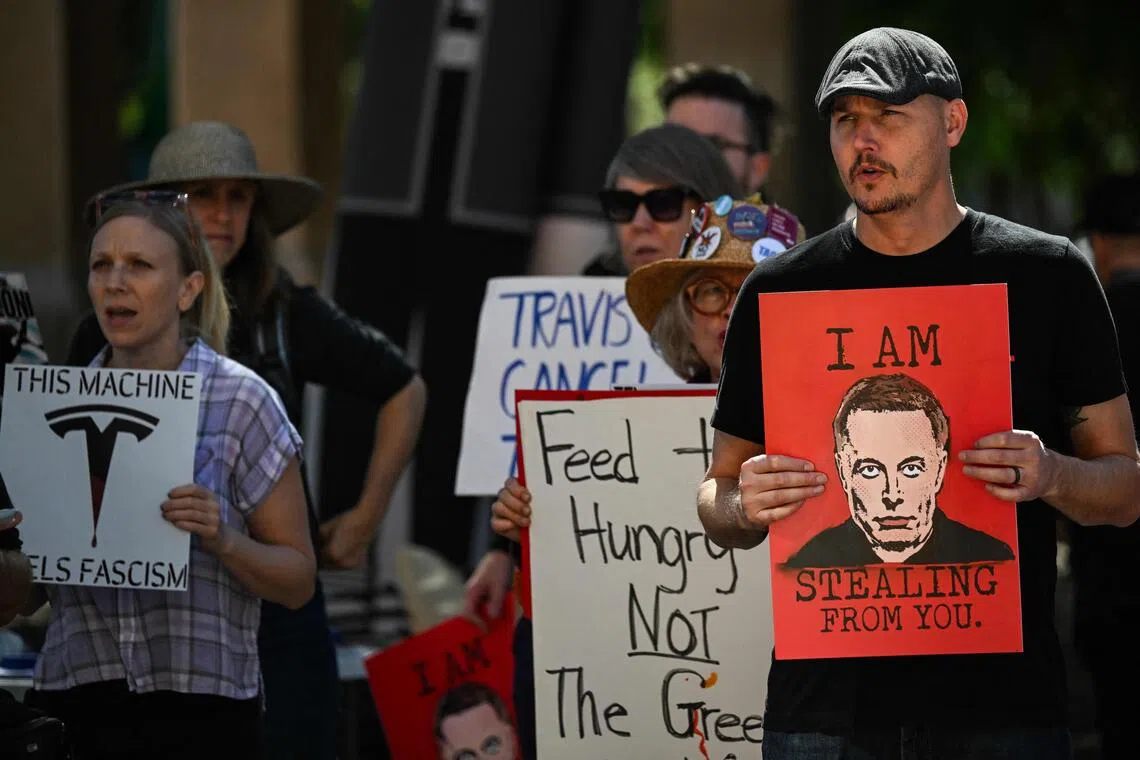 People protest during the 'No $1 Trillion for Elon Musk!' rally, at the Texas State Capitol, in Austin, on Nov 5. 