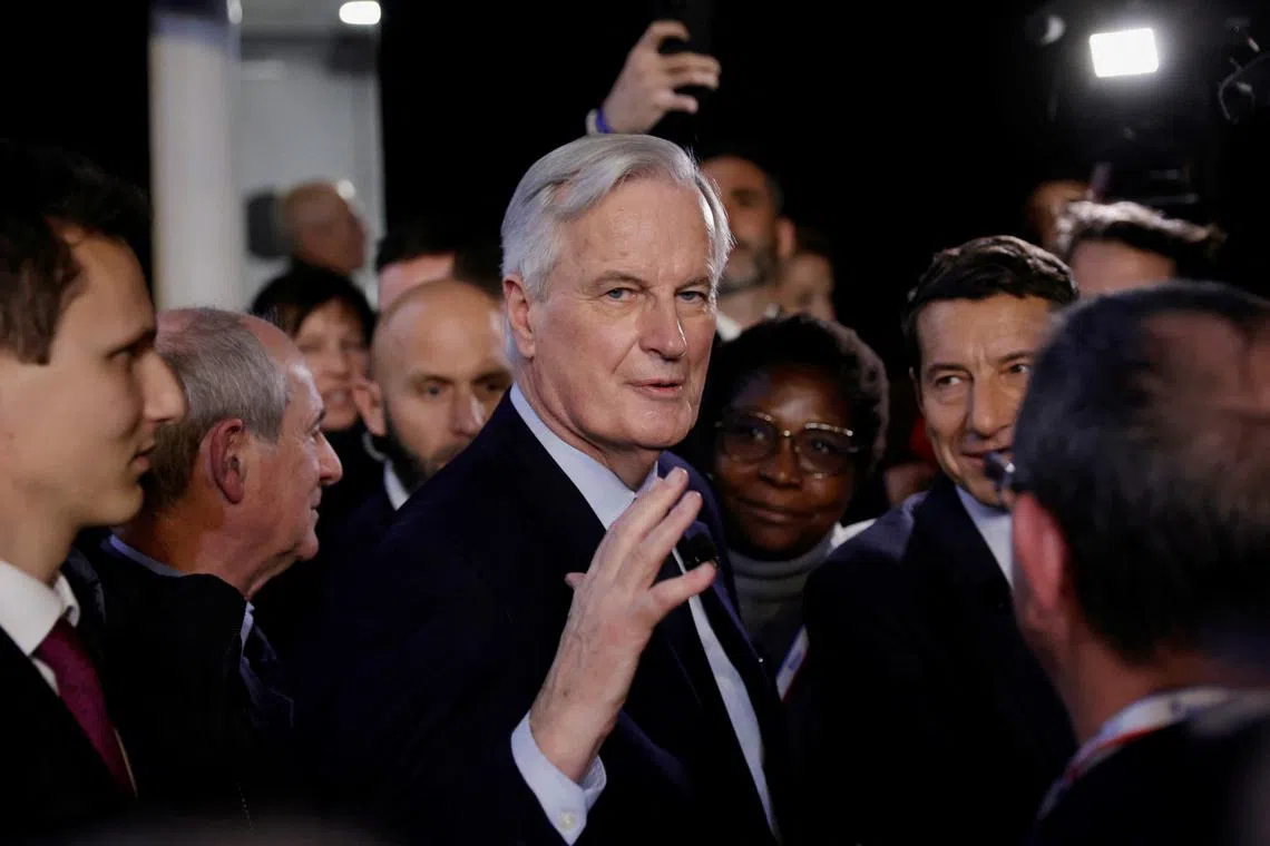 FILE PHOTO: French Prime Minister Michel Barnier leaves after his speech during the 106th session of the Congress of Mayors organised by the \"France's Mayors' Association\" (AMF), in Paris, France, November 21, 2024. REUTERS/Abdul Saboor/File Photo