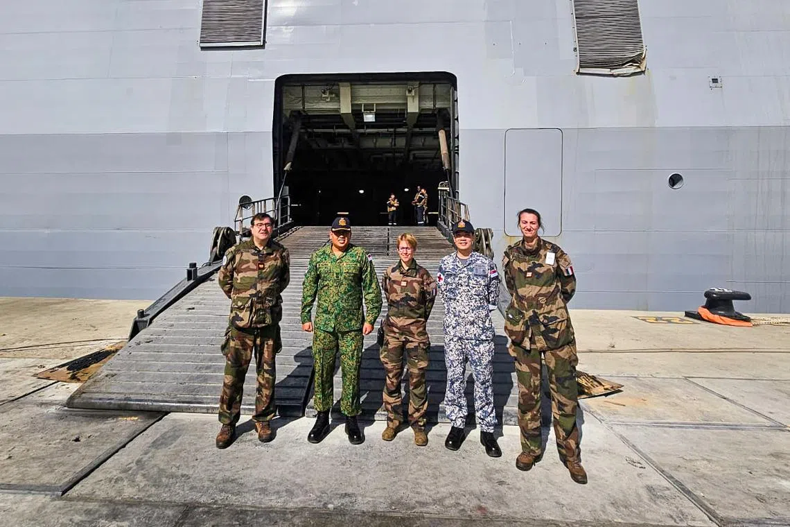 The team with French Armed Forces personnel prior to boarding FS Dixmude.