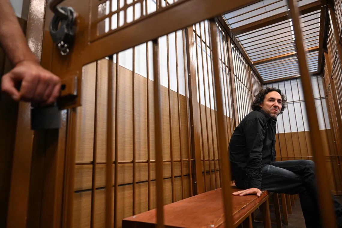 Laurent Vinatier, a French national who works with a Swiss-based conflict mediation non-profit organisation, sits inside the defendant's cage during his pre-trial detention hearing in Moscow on June 7, 2024. 