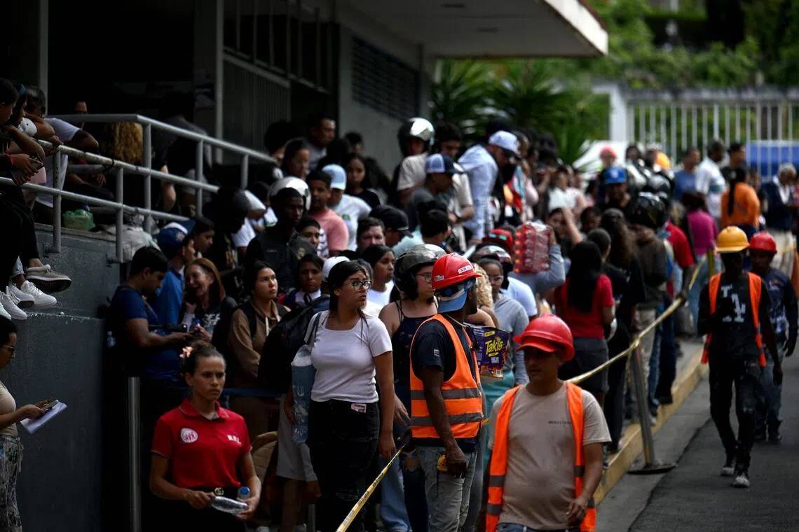 People gathering outside the Domingo Luciani hospital searching for relatives following twin earthquakes in Caracas, Venezuela on June 25.