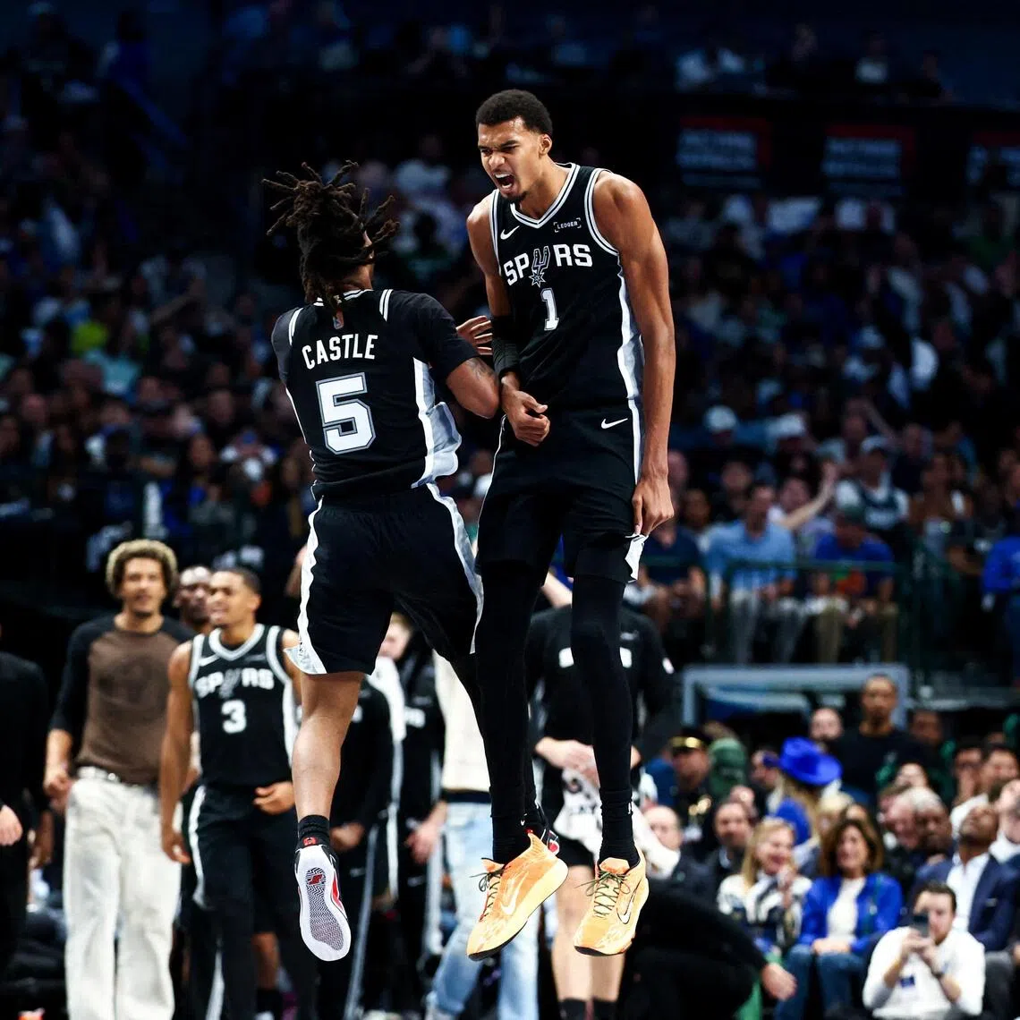 San Antonio Spurs forward Victor Wembanyama celebrates with guard Stephon Castle during the first half  against the Dallas Mavericks at American Airlines Center.