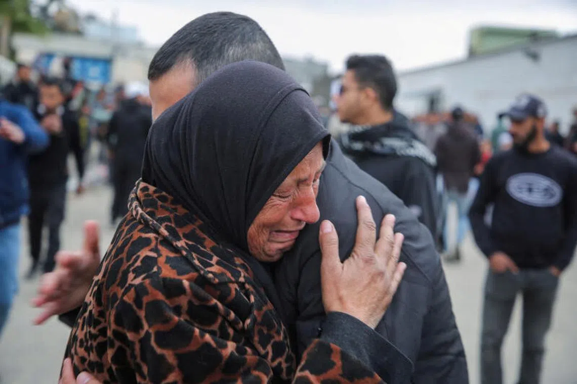 A woman cries as Palestinian prisoners are greeted after being released from an Israeli jail, as part of a hostages-prisoners swap and a ceasefire deal in Gaza between Hamas and Israel, in Khan Younis in the southern Gaza Strip, February 8, 2025. REUTERS/Hatem Khaled TPX IMAGES OF THE DAY