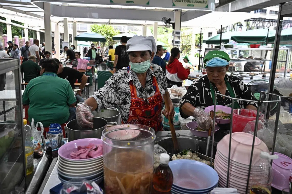 A street food vendor prepares noodles at the newly-opened Lumphini Hawker Centre in Bangkok on April 30. 