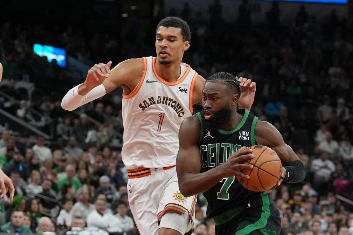 Boston Celtics guard Jaylen Brown drives past San Antonio Spurs centre Victor Wembanyama.
