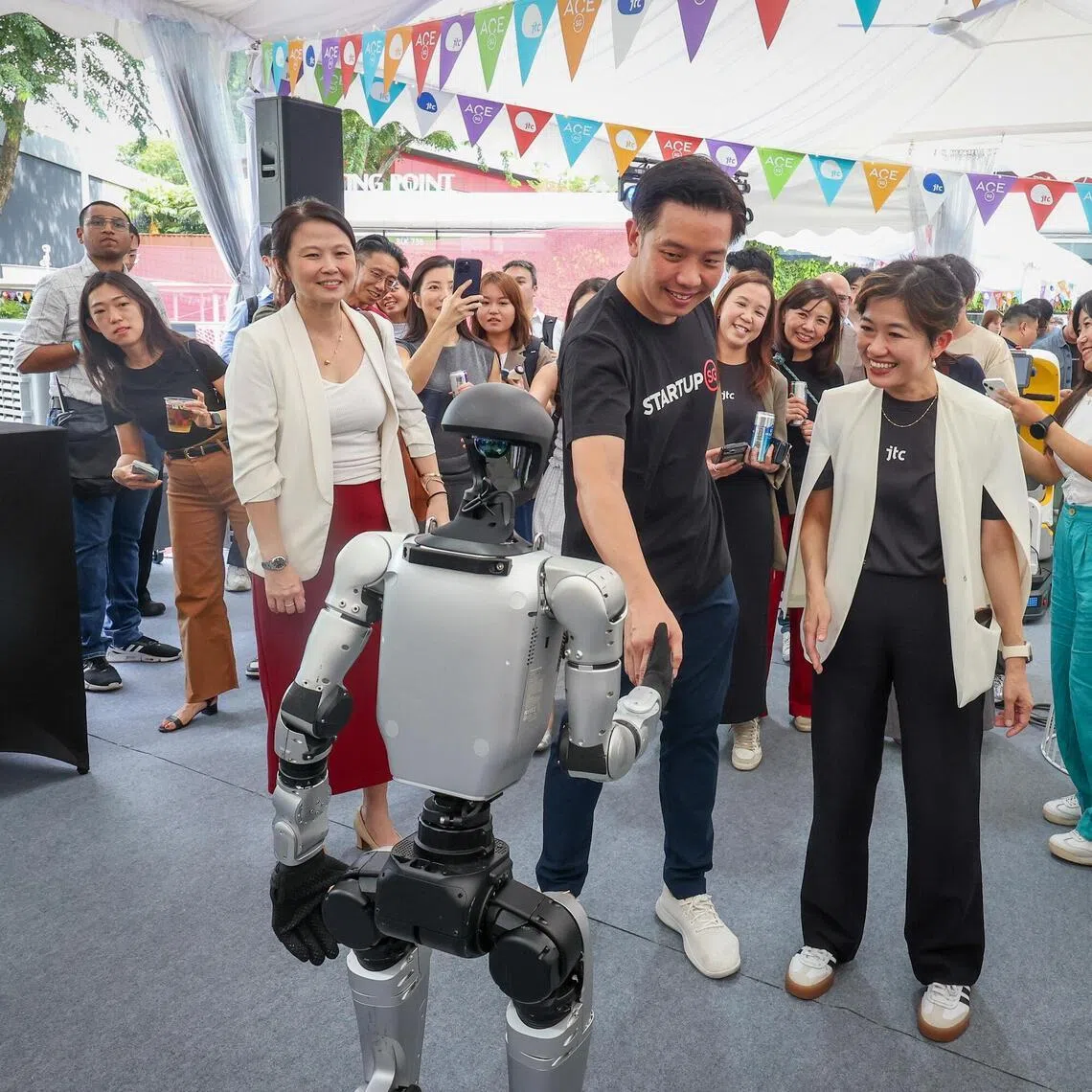 ST20260325_202622000988/bnjtc/Benjamin Lim/Jason Quah

(From left) Ms Emily Liew, Assistant Managing Director, Enterprise Singapore; Minister of State Alvin Tan; Ms Jacqueline Poh, JTC CEO interacting with a robot at the LaunchPad @ One-North Carnival, including the reopening of The Meeting Point, on March 25, 2026. ST PHOTO: JASON QUAH