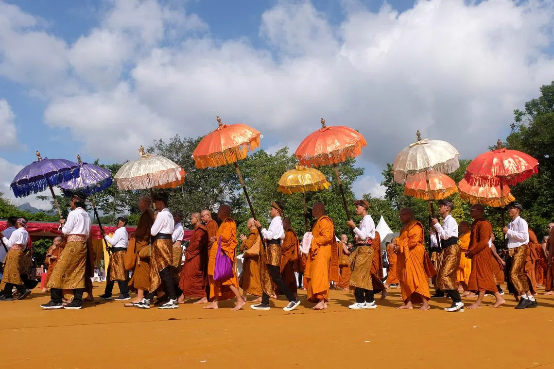 Buddhist monks walk at the Borobudur Temple complex during the celebration of Vesak day in Magelang, Central Java province, Indonesia, on June 4, 2023.