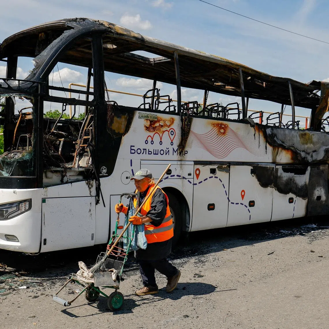 A worker walks at the site of a Ukrainian drone attack on a bus, according to local authorities in the course of the Russia-Ukraine military conflict, in the settlement of Yenakiievo in Donetsk region, a Russian-controlled part of Ukraine, June 3, 2026.  REUTERS/Alexander Ermochenko