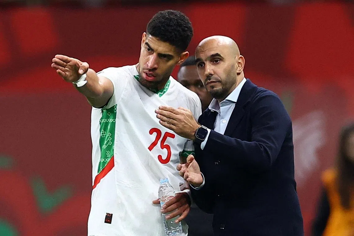 Soccer Football - CAF Africa Cup of Nations - Morocco 2025 - Quarter Final - Morocco v Cameroon - Prince Moulay Abdellah Stadium, Rabat, Morocco - January 9, 2026 Morocco coach Walid Regragui gives instructions to Morocco's Adam Masina. REUTERS/Siphiwe Sibeko
