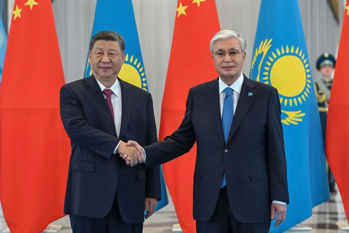 Kazakh President Kassym-Jomart Tokayev (right) and Chinese President Xi Jinping shaking  hands during their meeting in Astana, Kazakhstan, on June 16, 2025.