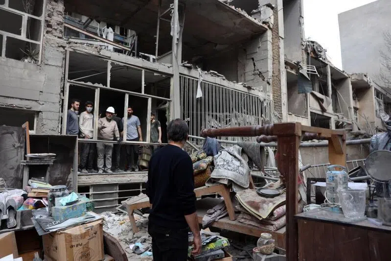 Iranians collect their belongings from damaged residential buildings in southern Tehran, Iran, on March 15.