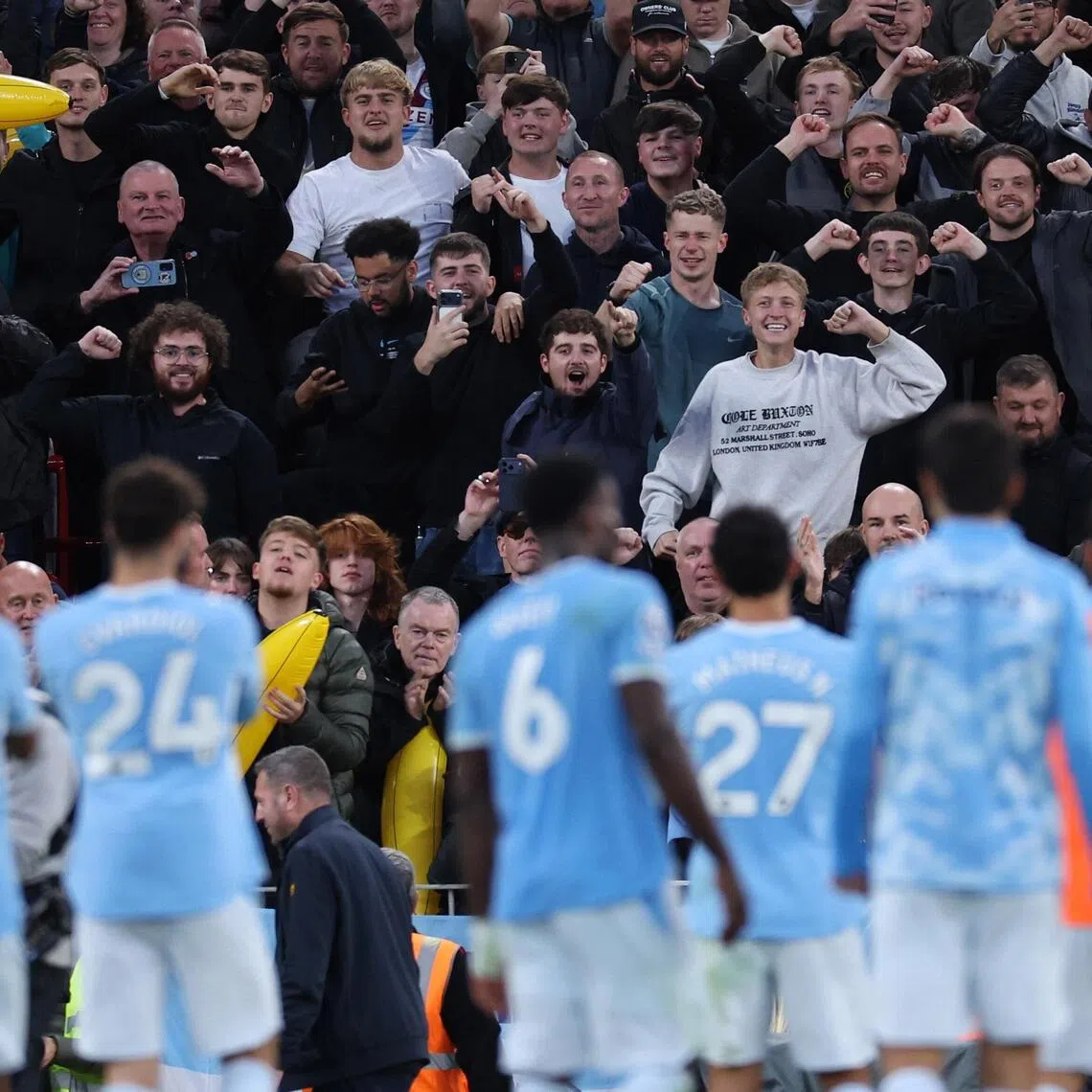 Manchester City players celebrating with fans after thrashing Liverpool 3-0 away in the English Premier League on Oct 11.