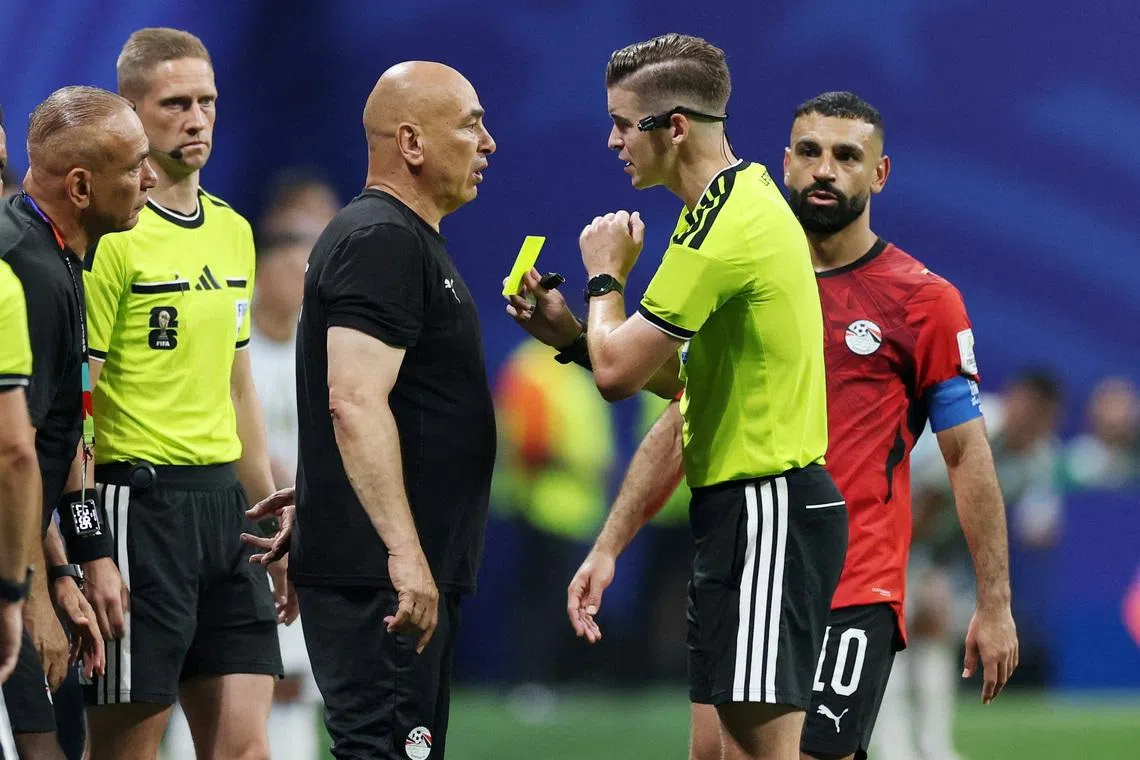 Egypt coach Hossam Hassan is shown a yellow card by referee Francois Letexier during his team’s round of 16 match against Argentina on July 7. Egypt went on to lose 3-2. Hassan said Egypt was “cheated”.