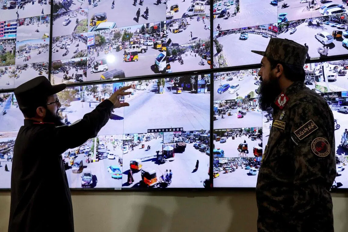 Taliban security personnel watch CCTV surveillance feeds of the city from the control room at the police headquarters in Herat on Oct 7.