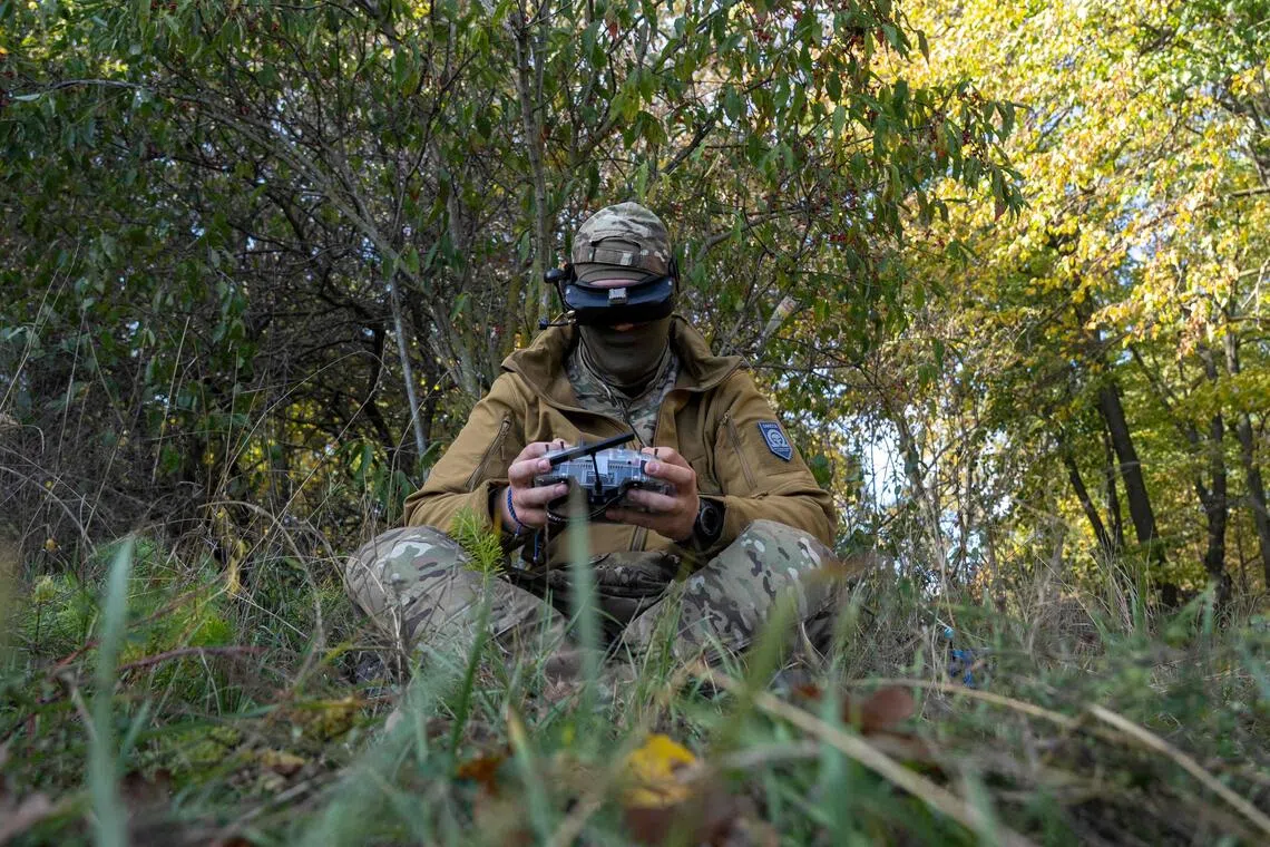 A Ukrainian serviceman using a remote control to fly an FPV drone, during a training exercise at an undisclosed location on Oct 20, amid Russia’s invasion of its neighbour.