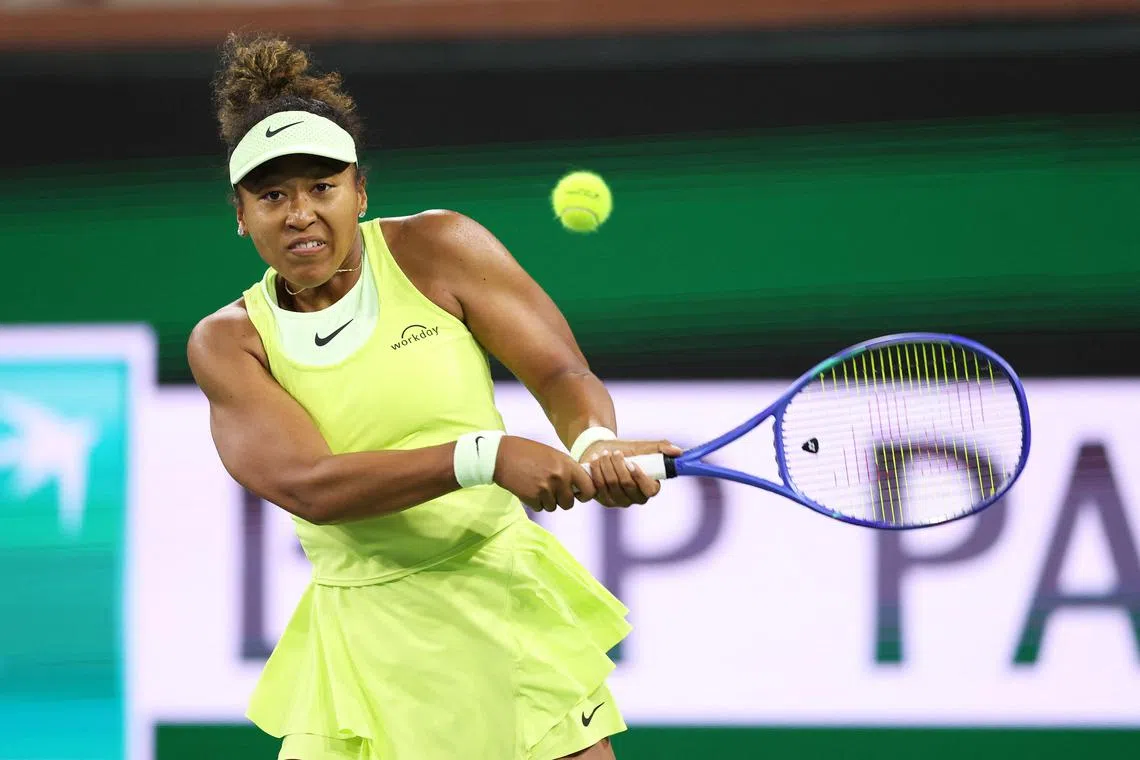Naomi Osaka of Japan plays a backhand against Camila Osorio of Colombia in their first-round match at Indian Wells.