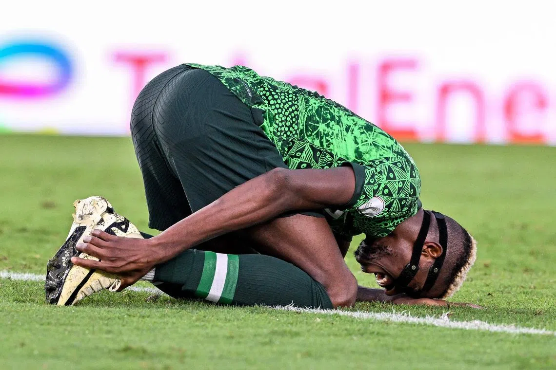 Nigeria forward Victor Osimhen reacting after picking up an injury during the Africa Cup of Nations quarter-final football match between Nigeria and Angola at the Felix Houphouet-Boigny Stadium in Abidjan on Feb 2. He is a doubt for their semi-final against South Africa on Feb 5.