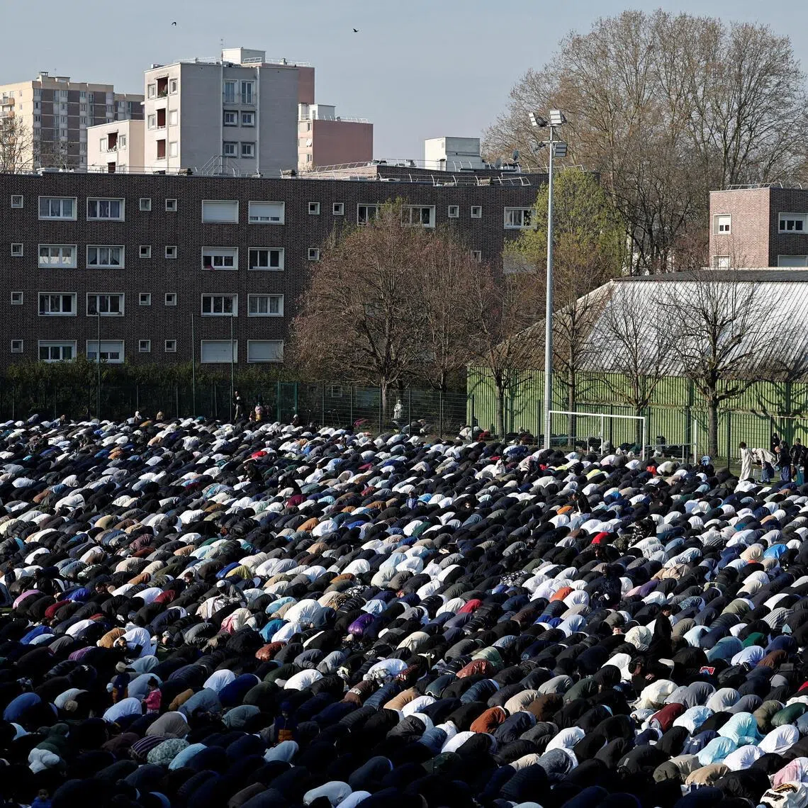 The Muslim faithful attend the Eid al-Fitr prayers, marking the end of the fasting month of Ramadan, at Stade Auguste-Delaune in Saint-Denis, near Paris.  