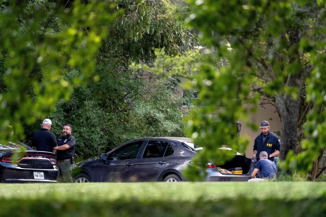 Law enforcement personnel gathered outside the home of gunman Joshua Jahn, in Fairview, Texas, on Sept 24.