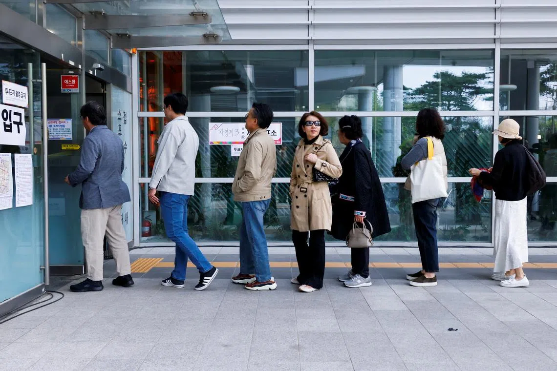 People queue to vote at a polling station during the 22nd parliamentary election in Seoul, South Korea, April 10, 2024. REUTERS/Kim Soo-hyeon