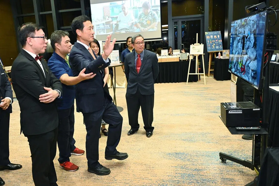 Health Minister Ong Ye Kung trying his hand at a virtual therapy system during St Luke’s Hospital’s 28th anniversary charity dinner on Sept 13.