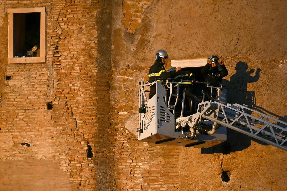 Firefighters at work after the partial collapse of a medieval tower in Rome on Nov 3.
